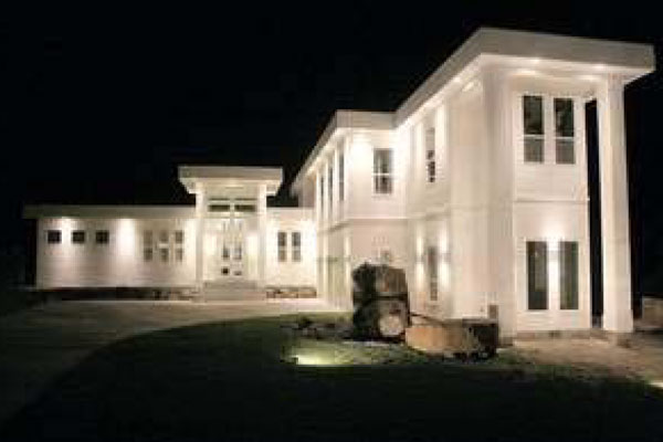 Turel's home at night with light on.